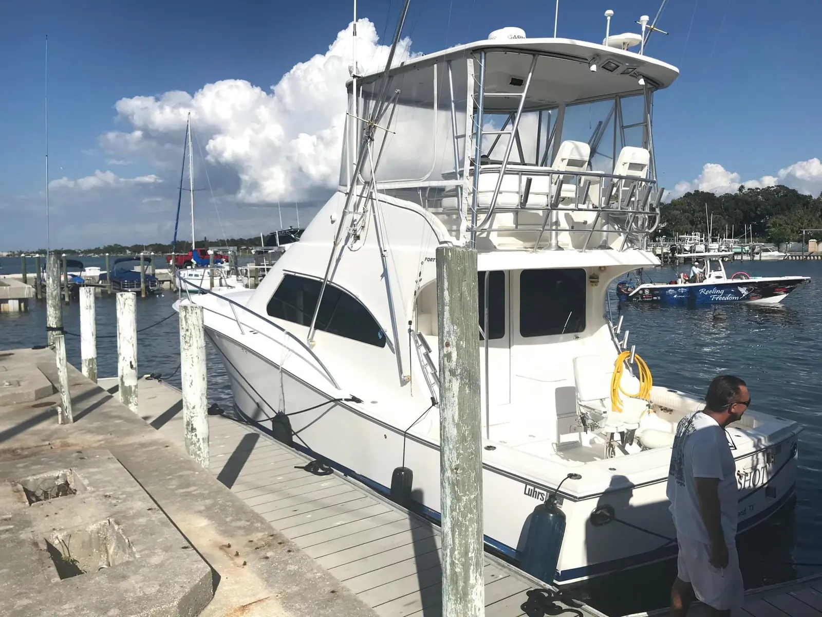 Sportfishing boat alongside a dock during a mobile marine service visit