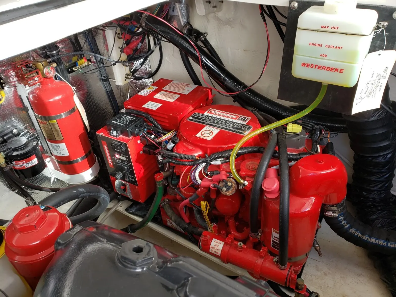 Marine engine bay showing red fuel filter and water separator housings