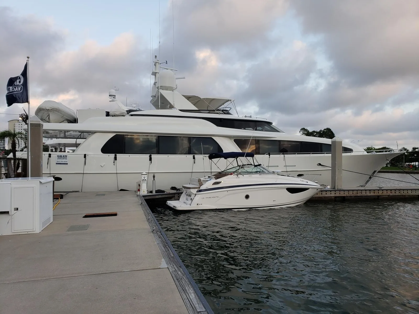 Motor yacht alongside a dock being prepared for a sea trial