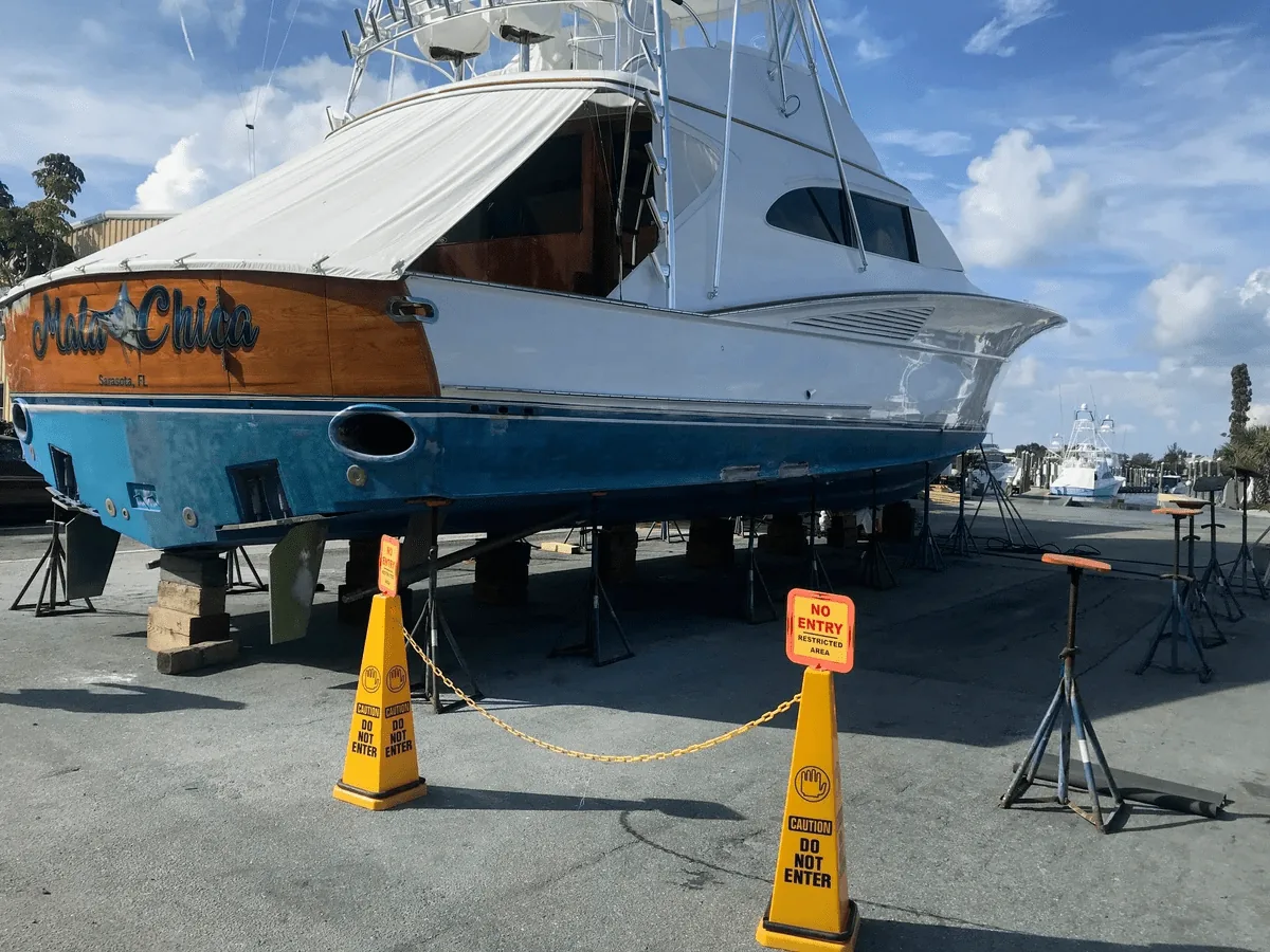 Sportfishing yacht hauled out on stands at a boatyard