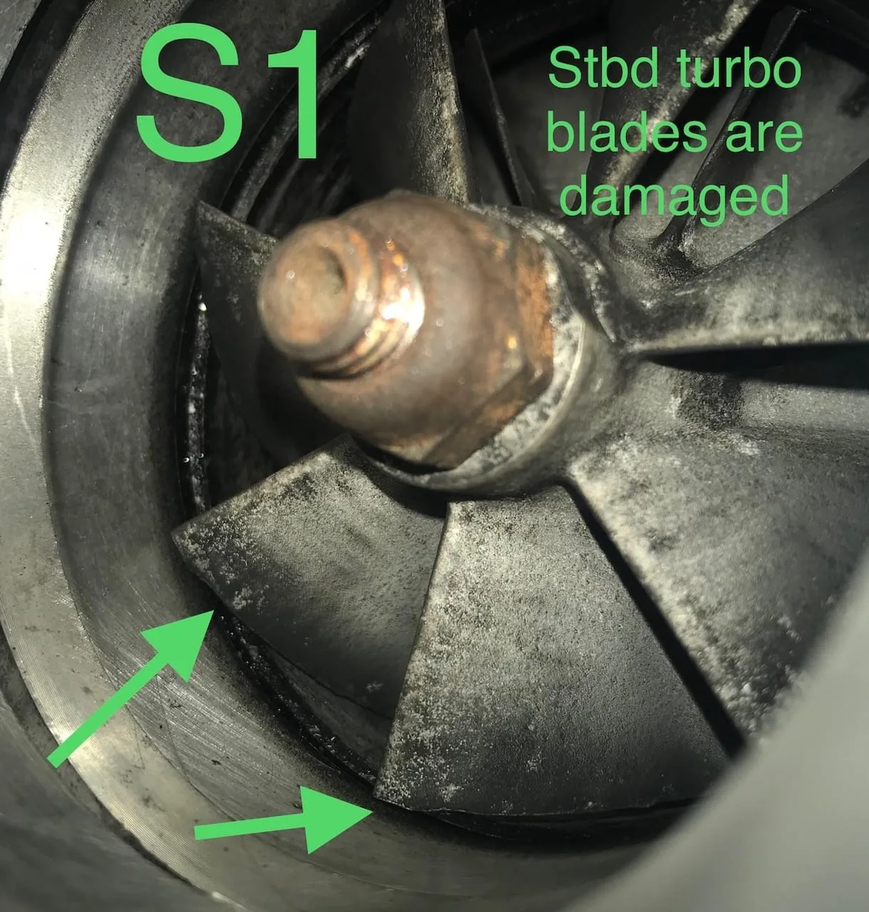 Survey finding photograph marked S1 showing damaged starboard turbocharger blades with green callout arrows